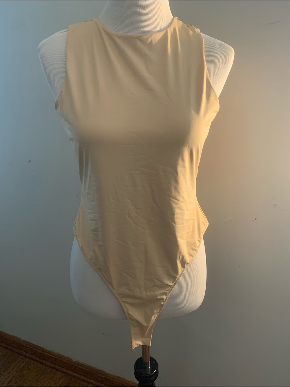Sleek High-Cut Sleeveless Bodysuit in Cream